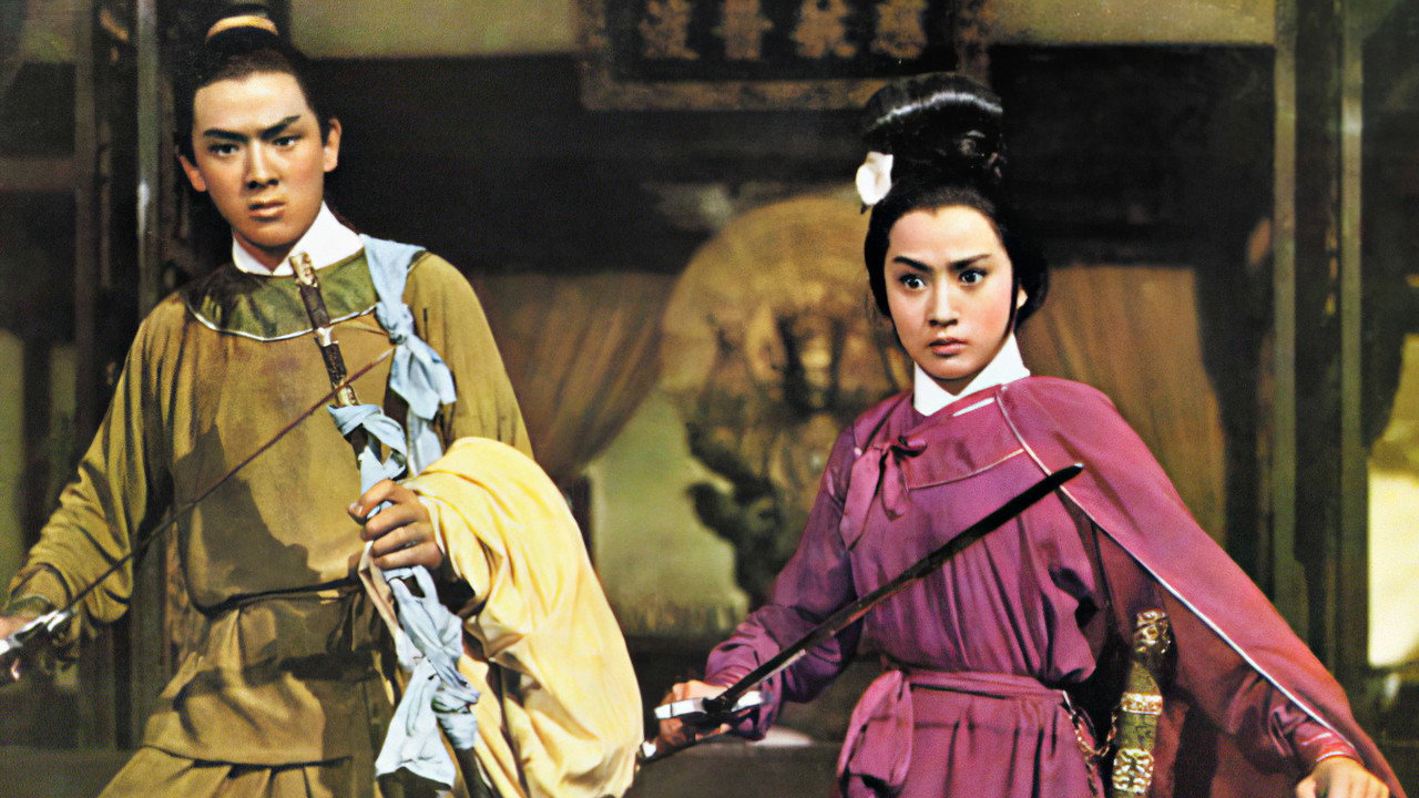 Jimmy Wang Yu, in a mustard-colored tunic and pants and Chin Ping in a raspberry colored outfit wield swords and look dramatically surprised.