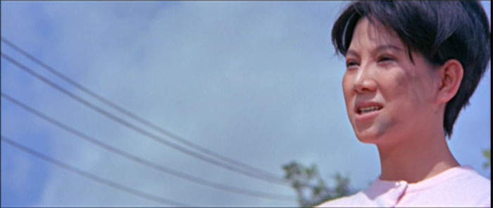 Ivy Ling Po with a grease-smudged face stands outside